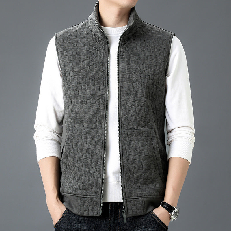 Man wearing gray casual sleeveless top waistcoat over white long sleeve shirt with hands in pockets