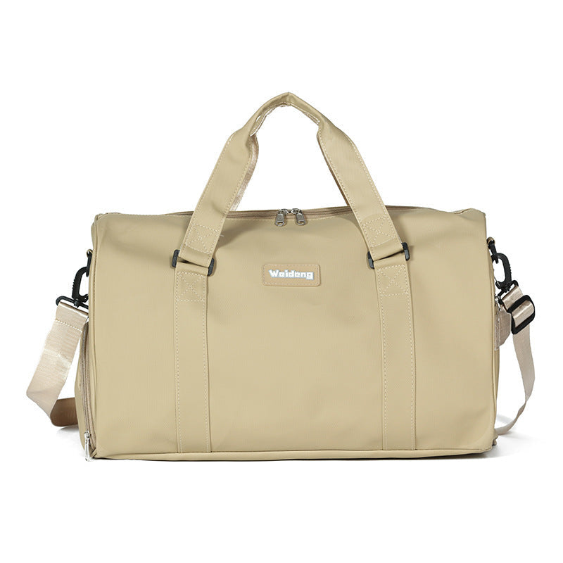 Beige portable female large capacity swimming bag with dual handles and adjustable shoulder strap.