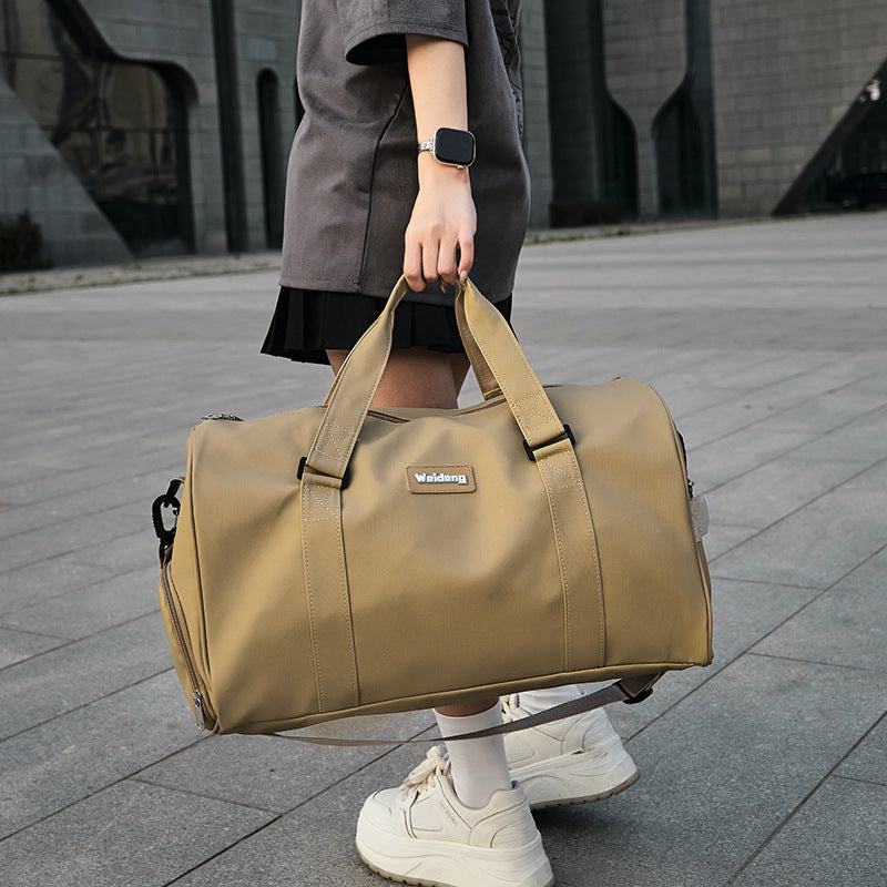 portable female large capacity swimming bag in brown oxford cloth carried by woman outdoors