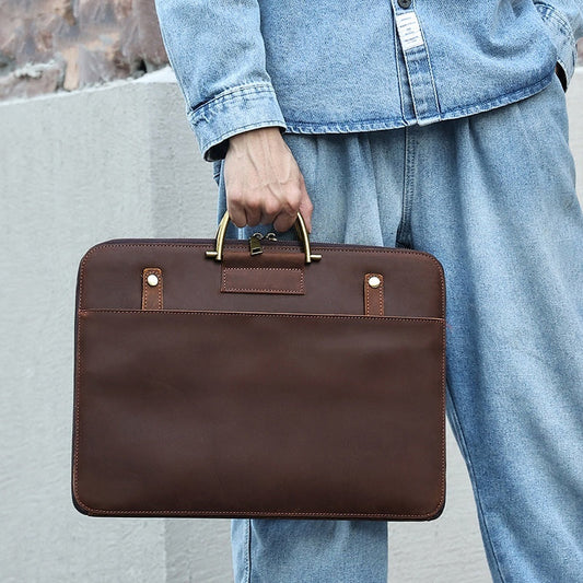 Man holding brown Crazy Horse leather men's business handbag with brass handles