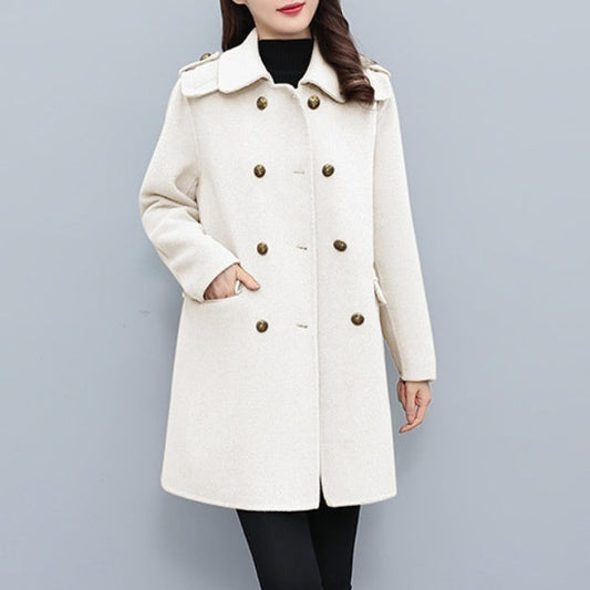 Woman wearing a cream Korean style wool double-breasted coat with gold buttons and side pockets.
