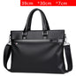 Large capacity black soft leather business handbag with handles and detachable shoulder strap, zipper closure, suitable for 14-inch laptop.