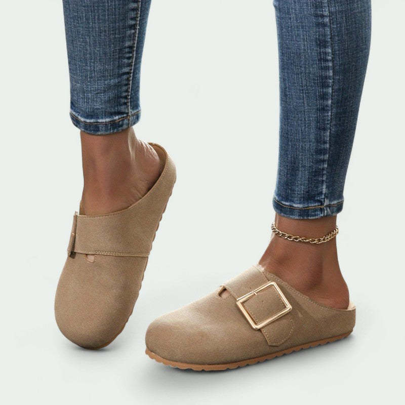 Women's closed toe low top khaki canvas slippers with buckle detail worn with jeans