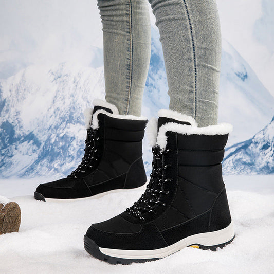 Black cotton-padded waterproof snow boots with non-slip rubber sole and white fleece lining, mid-calf height, worn with jeans in snowy outdoor setting