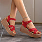Red women's platform suede sandals with buckle straps and woven textured sole