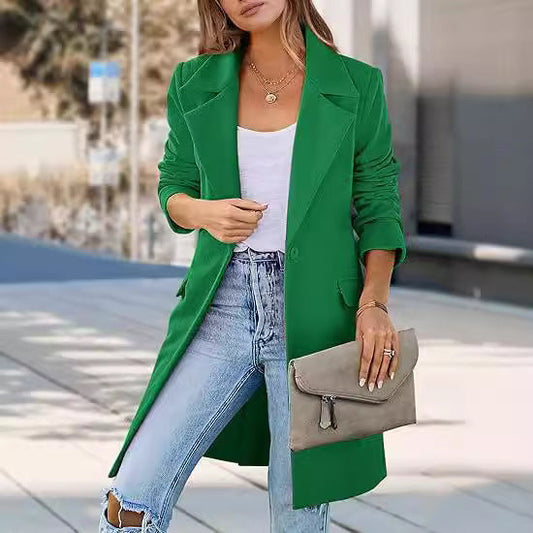 Stylish women's fashion green long woolen cardigan coat with oversized lapels worn with jeans and white top, accessorized with a gray clutch bag.