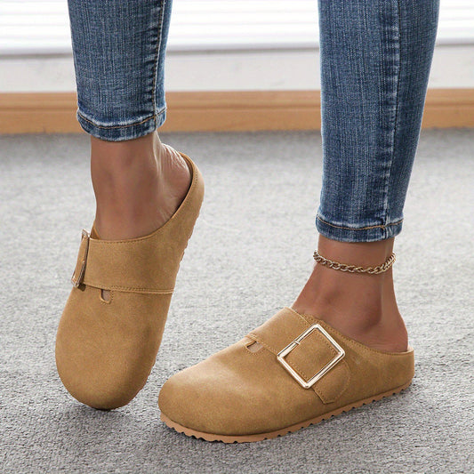 Women's closed toe low top canvas slippers in brown with buckle detail, worn with jeans
