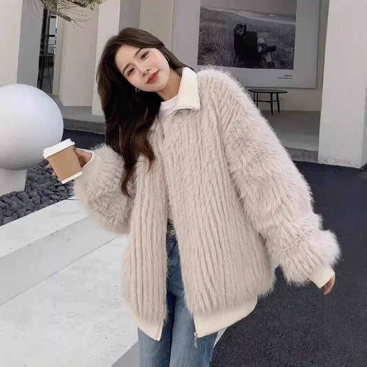 Woman wearing a beige Stand Collar Vertical Bar faux fur coat holding a coffee cup outdoors