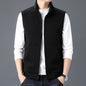 Black casual sleeveless top waistcoat vest with zipper front and pockets, worn over white long sleeve shirt