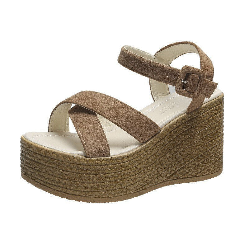 Brown women's platform suede sandal with buckle strap and textured wedge sole