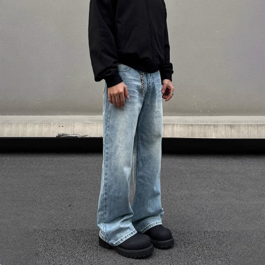 Men's retro whisker washed blue straight jeans with visible stitching and flared wide-leg style, worn with black shoes and hoodie